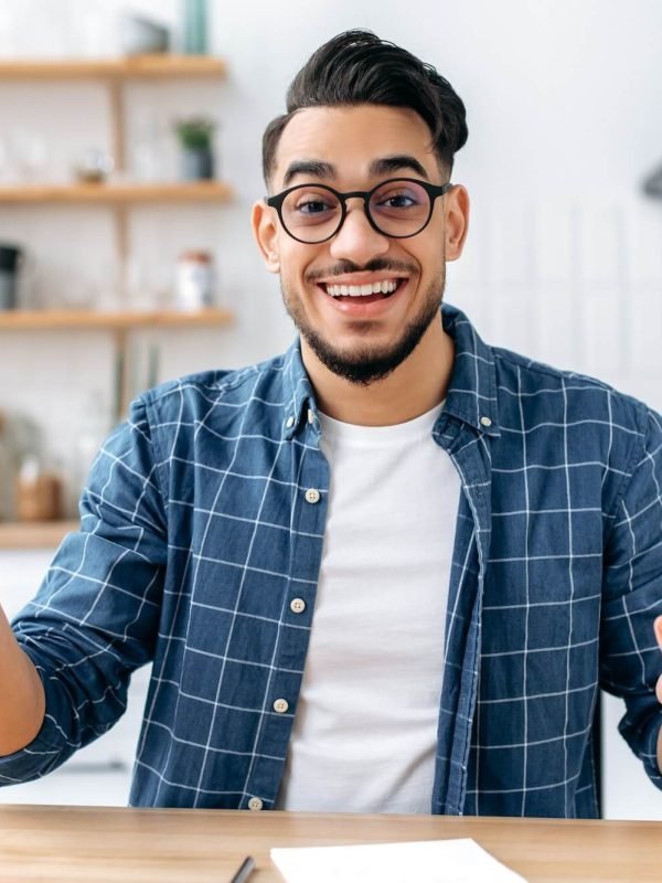 Friendly indian or arabian man, business leader or coach, conducts a business meeting with