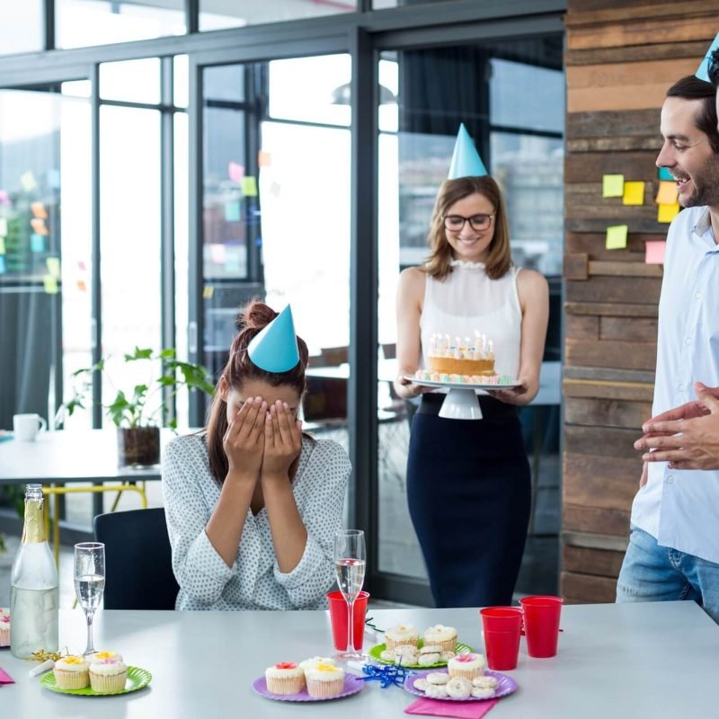 businesspeople-giving-surprise-birthday-party-to-colleague