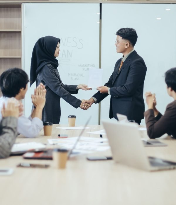 Manager awarding workers during meeting